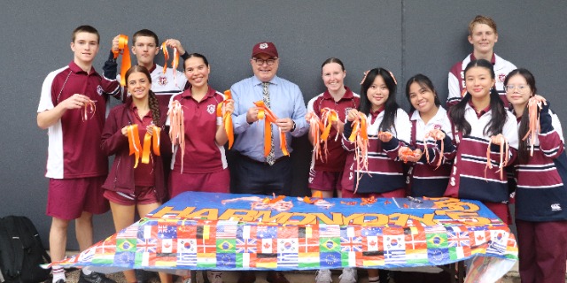 Students holding Harmony Day ribbons