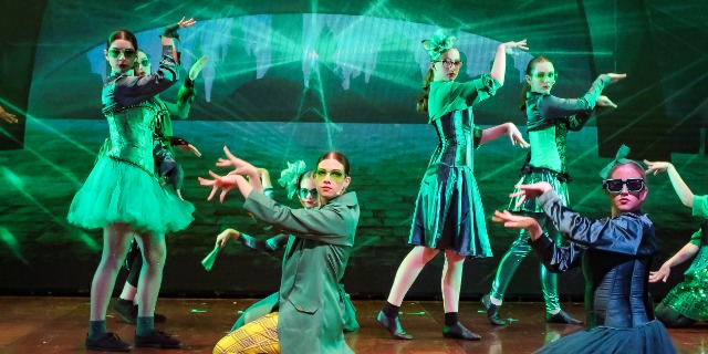 Clairvaux MacKillop students dressed in green on stage.