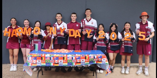 Students holding Harmony Day sign.