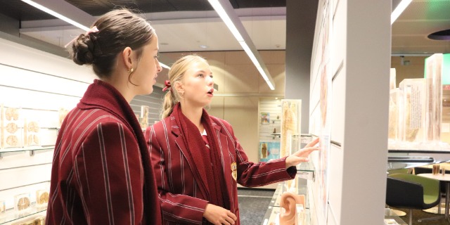 Two students at a museum exhibition.