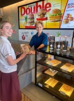 Student with mentor in a fast food store.