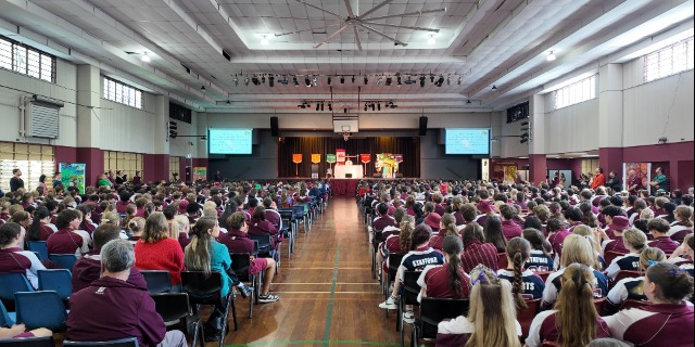 Founders' day liturgy. Large group of people are seated in the hall.